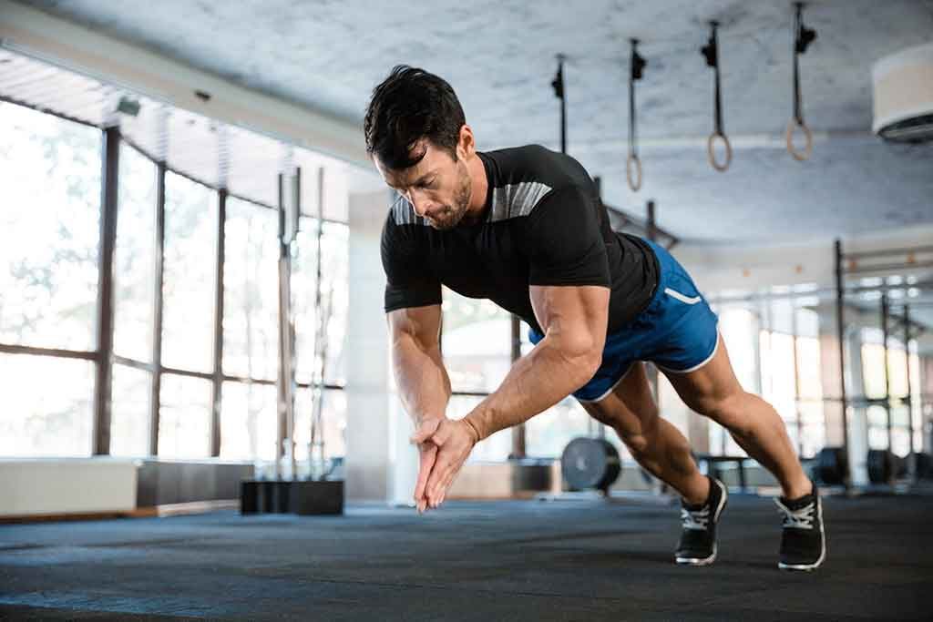 Male athlete doing power pushup and clapping hands together