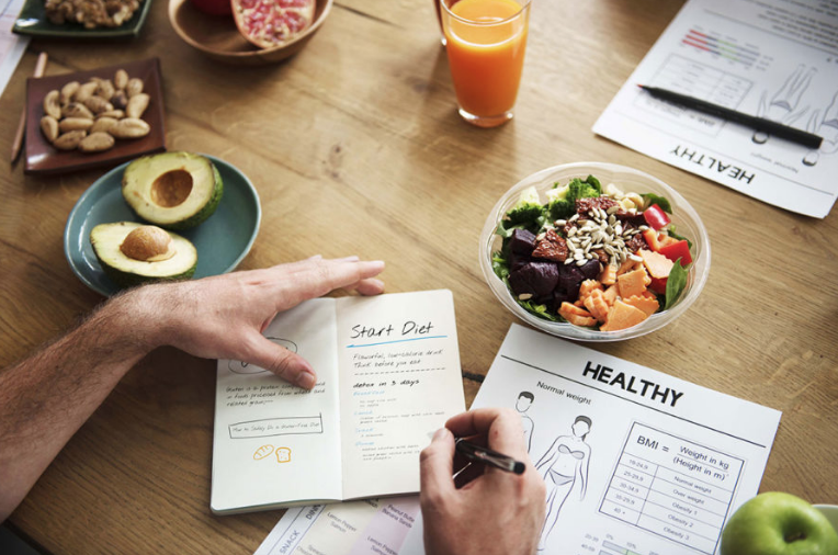 Dietician writing a meal plan for certificate in nutrition
