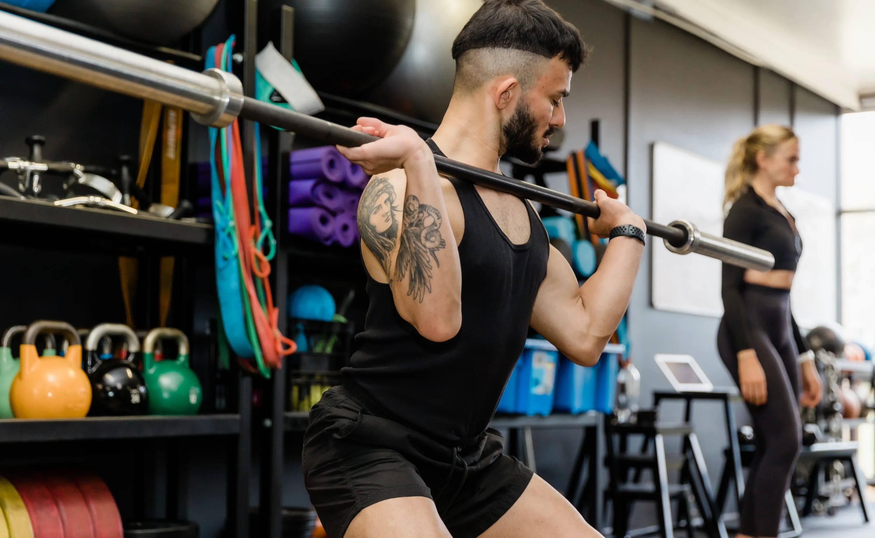 Male personal trainer performing an upper body exercise