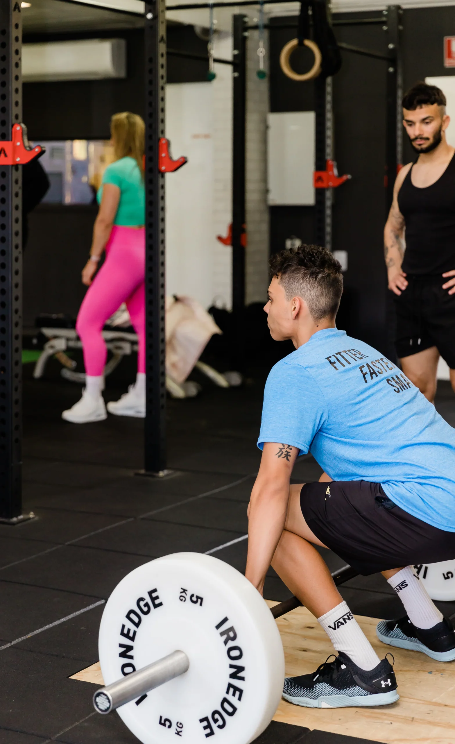 Certified PT watching client perform a dead lift exercise