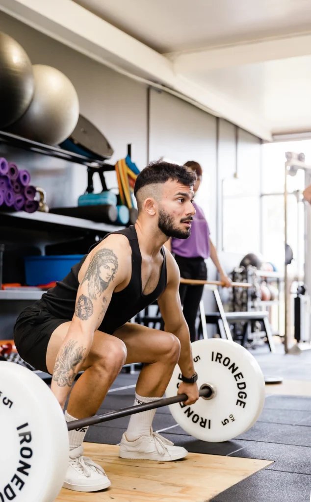 Male individual preparing to perform a deadlift exercise