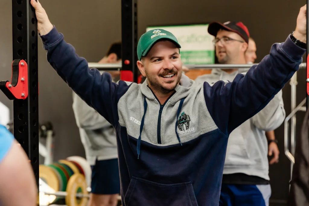 Young personal trainer smiling during PT course in gym