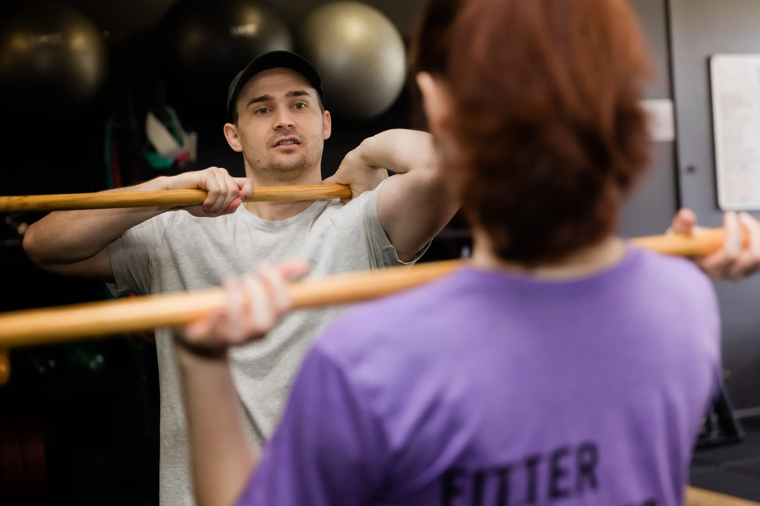 Expert personal trainer demonstrating movement to client