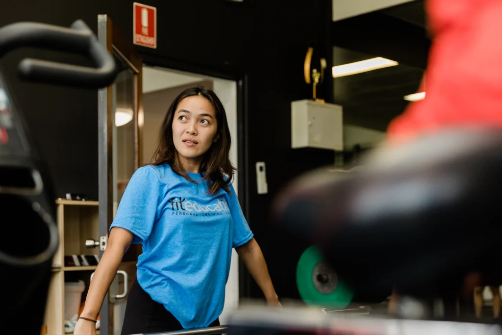 Female client attentively listening to trainer in gym