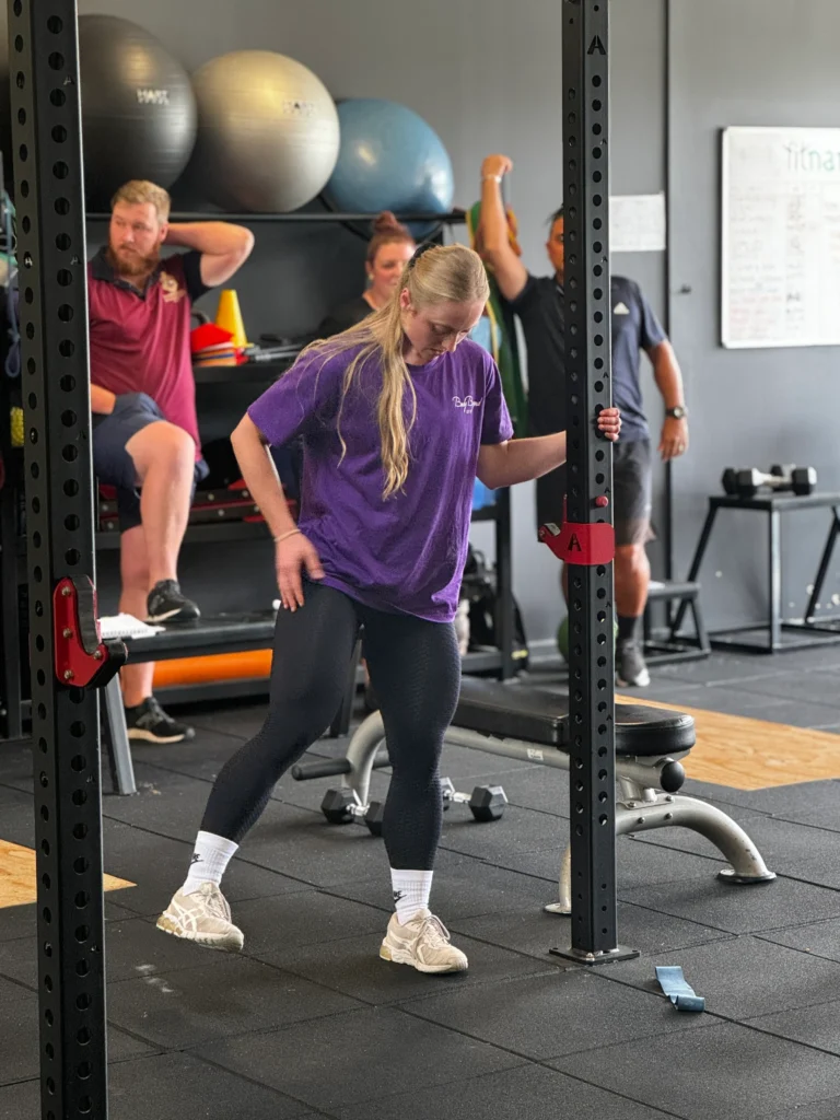 Female training student performing exercise in class