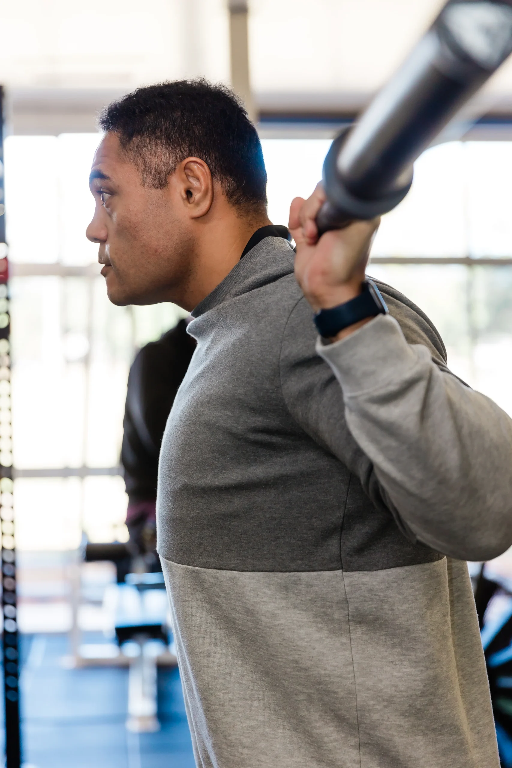 Trainer demonstrating lifting weights technique